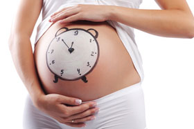 Zeichnung einer Uhr auf dem Bauch einer Schwangeren